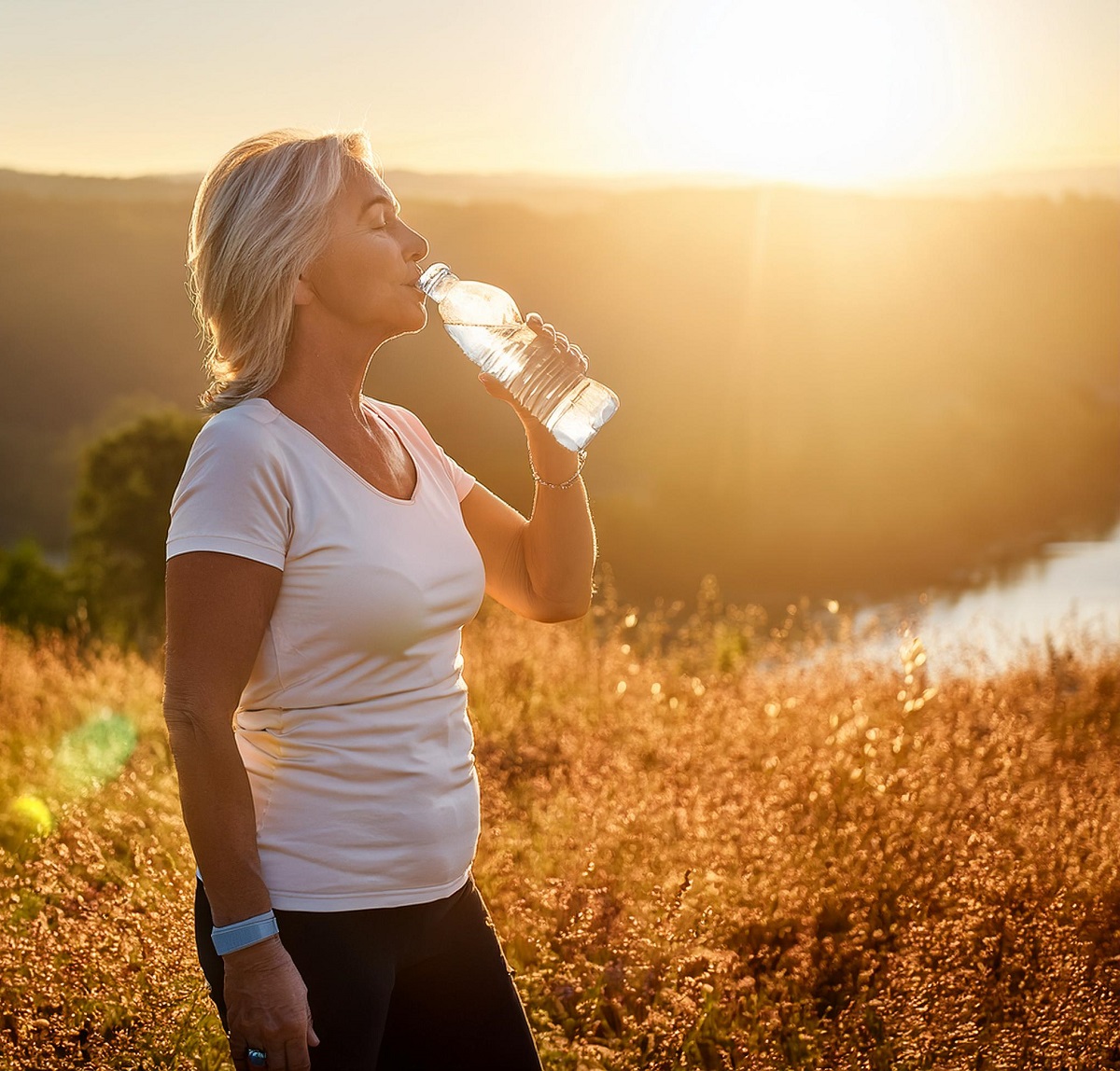 Woman drinks water in the sun