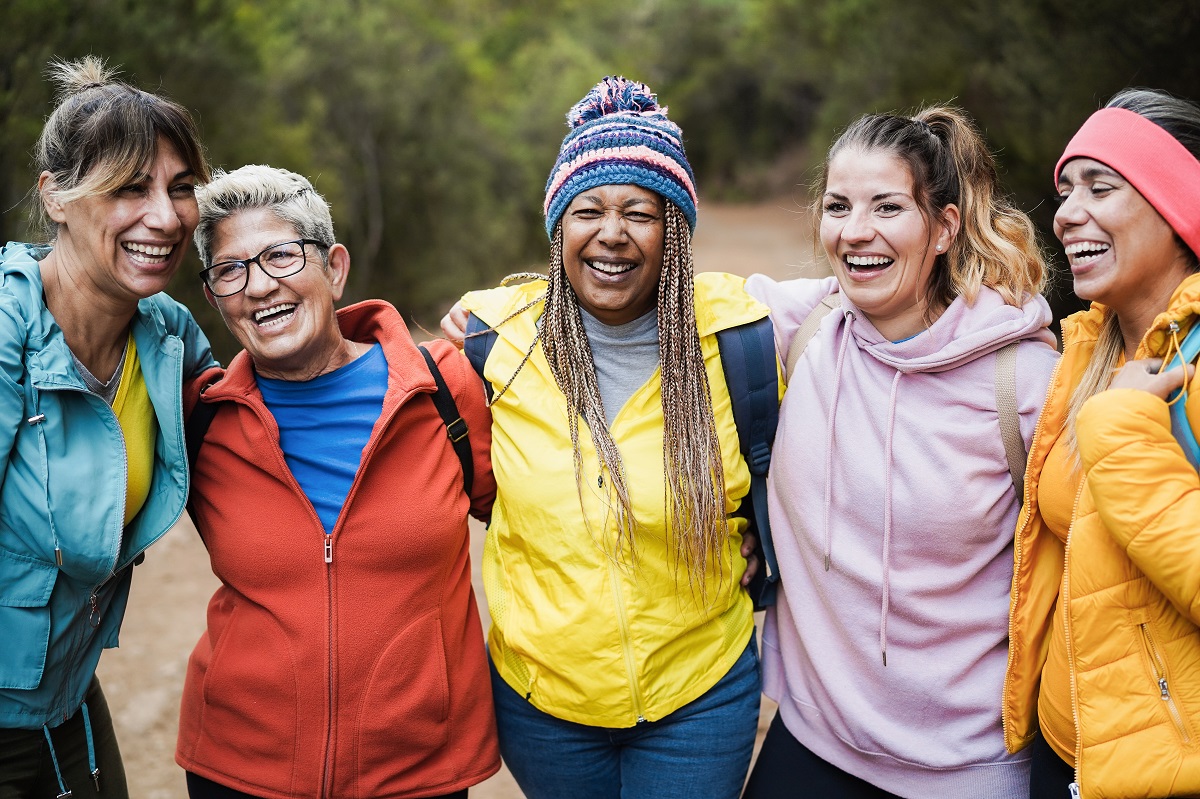 Five friends laughing and smiling