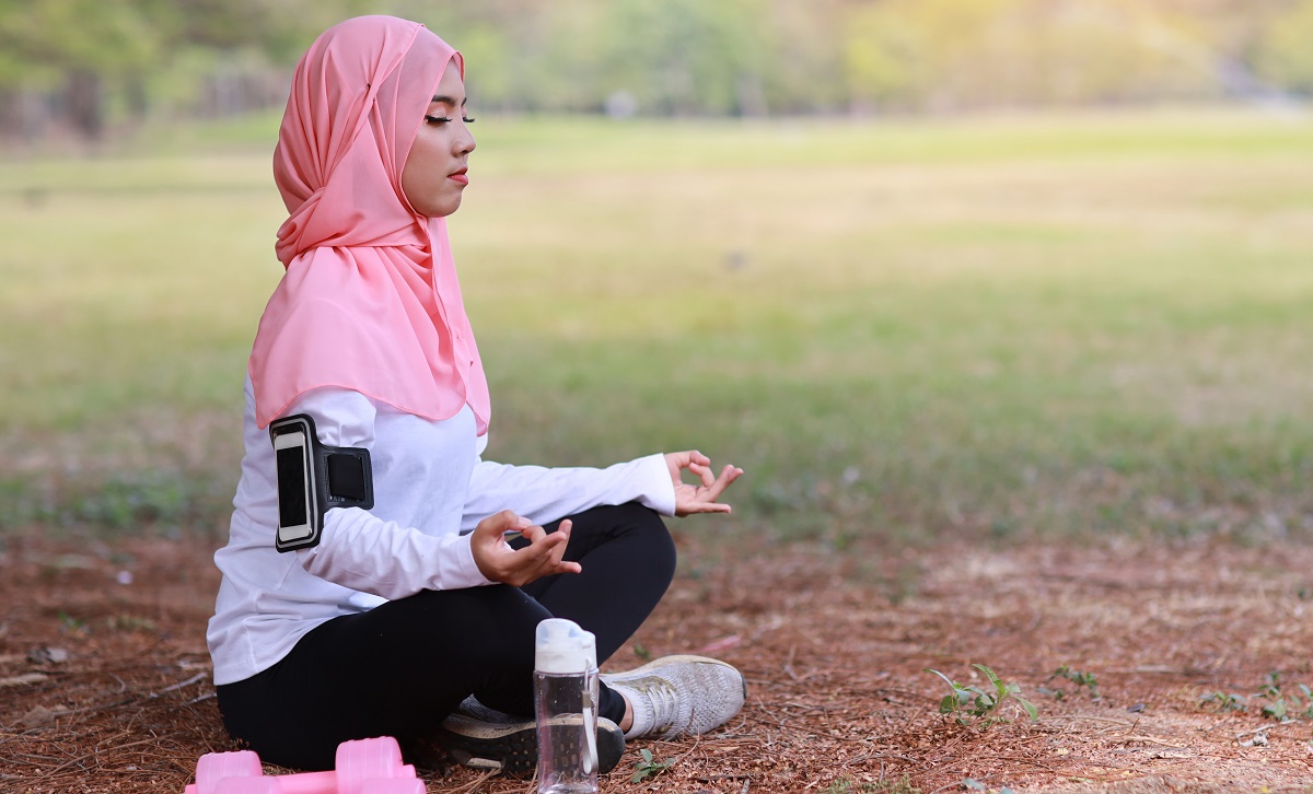 Woman meditates outside
